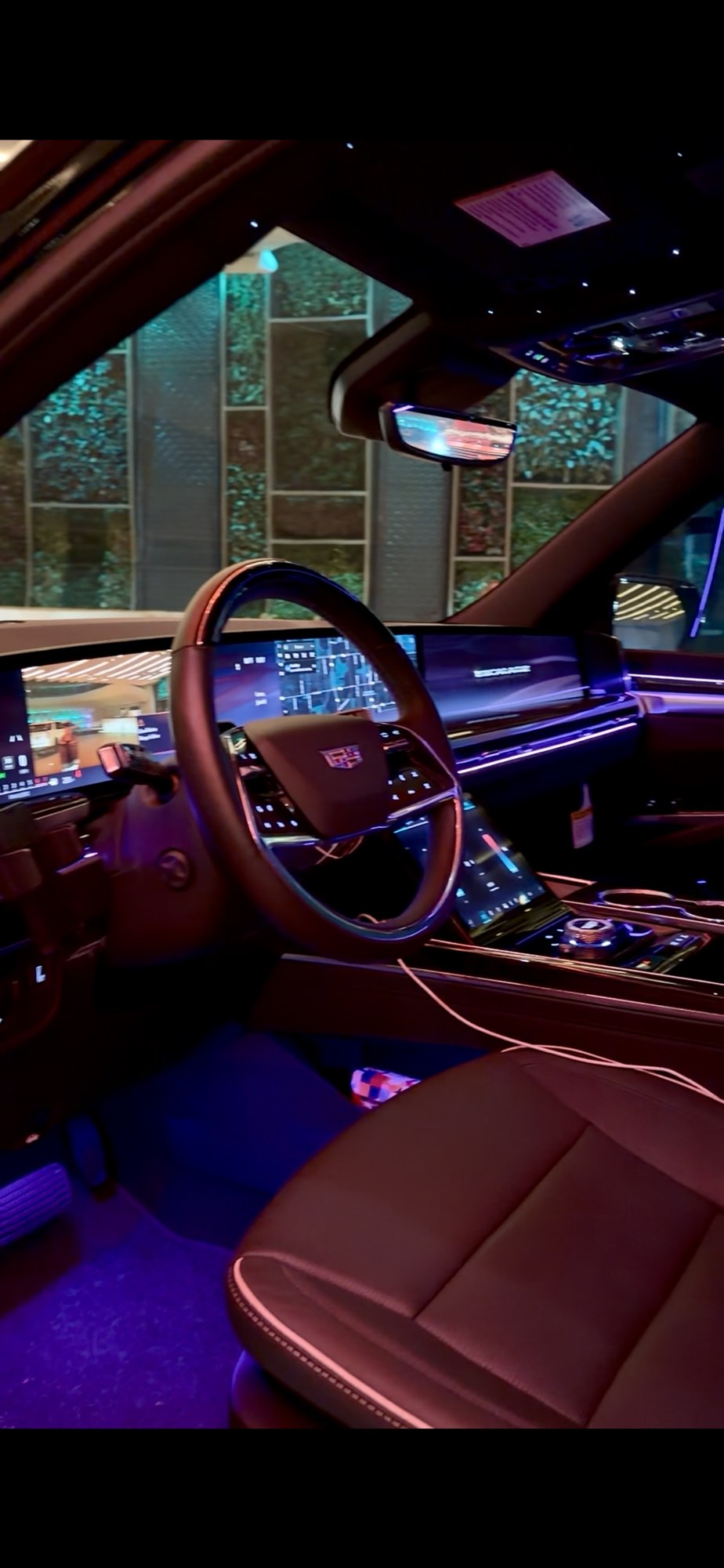 Cadillac Escalade front cabin with leather seating and ambient lighting